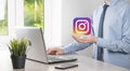 Onok,Ukraine - July 14,2021:Businessman holds, clicks, INSTAGRAM icon in his hands.Social network.global network and data customer
