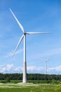 Onshore electrical wind farm, using several horizontal axis turbines, summer day Royalty Free Stock Photo