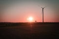 onshore wind turbine on a meadow at sunset. Renewable energy. Clean electricity