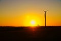 onshore wind turbine on a meadow at sunset. Renewable energy. Clean electricity