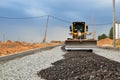 ÃÂ¡onstruction machine Motor Grader at a construction site level the ground and gravel stones for the construction of a new asphalt