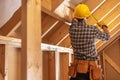 ontractor Worker Taking Measurement Inside Wooden Frame Structure