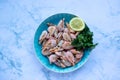 ÃÂ¡ooked shrimp with parsley and lemon in a blue ceramic bowl on a white marble table background. Healthy Mediterranean seafood. Royalty Free Stock Photo