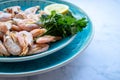 ÃÂ¡ooked shrimp with parsley and lemon in a blue ceramic bowl on a white marble table background. Healthy Mediterranean seafood. Royalty Free Stock Photo