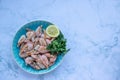 ÃÂ¡ooked shrimp with parsley and lemon in a blue ceramic bowl on a white marble table background. Healthy Mediterranean seafood. Royalty Free Stock Photo