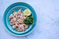 ÃÂ¡ooked shrimp with parsley and lemon in a blue ceramic bowl on a white marble table background. Healthy Mediterranean seafood. Royalty Free Stock Photo