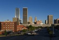 Looking across from Bricktown, towards downtown Oklahoma City with many tall buildings and bright early morning sunshine