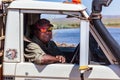 Oombulgurri WA Australia - Sep 2 2014: An Australian indigenous community leader sits in his four wheel drive vehicle on the