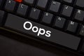 Oops isolated on laptop keyboard background