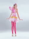 Oops, you caught me. A full length shot of a cute fairy dressed in pink.