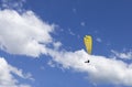 Oostduinkerke, Belgium - June 19, 2019: A paraglider is floatring in the air between wihte clouds Royalty Free Stock Photo