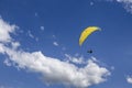 Oostduinkerke, Belgium - June 19, 2019: A paraglider is floatring in the air between wihte clouds Royalty Free Stock Photo