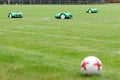 Automatic robotic lawnmower on green grass in the stadium