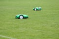 Automatic robotic lawnmower on green grass in the stadium