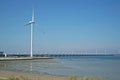 Oosterscheldekering with windmill seen from the shore of Noord Beveland Royalty Free Stock Photo