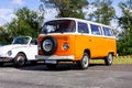 Oostmalle, Belgium - August 19 2023: An orange and white vintage old timer volkswagen split bus, camper, minibus or minivan Royalty Free Stock Photo