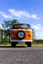 Oostmalle, Belgium - August 19 2023: An orange and white vintage old timer volkswagen split bus, minibus, minivan or camper