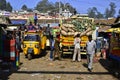 Menworkers loading truck with heavy bags with vegetables