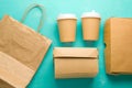 flat lay recyclable types of paper packaging on a blue background, paper bag, disposable glass, cardboard box