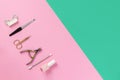 Op view of manicure and pedicure equipment on pink and green graphic background