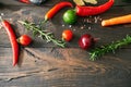 op view of various fresh vegetables and herbs on dark wooden table with copy space Royalty Free Stock Photo