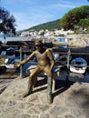 Opatija, golden fisherman`s statue in little a shelter for the vessels, Croatia