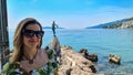 Opatija - A woman with big sunglasses posing with the Maiden with the Seagull statue Royalty Free Stock Photo