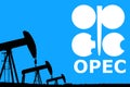 OPEC logo and silhouette industrial oil pump jack on rustic blue background Royalty Free Stock Photo