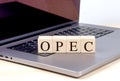 OPEC word on wooden block on laptop , business concept