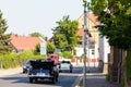 A Opel Admiral drives down a city street.