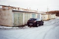 Opel Astra among garages in Kadan in Czechia 11. December 2023 on film photo- blurriness and noise of scanned 35mm film were