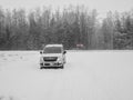Opel Combo Life passenger van on a snowy road on a cloudy winter day. Royalty Free Stock Photo