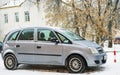 Opel Meriva parked in winter near the house.