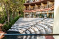 Open-air amphitheater for evening performances at a coastal hotel, surrounded by lush vegetation