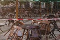 Open-air cafe in vintage style - closed. Red and white lines of barrier tape, protects for no entry concept: emergency,