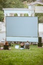 open air cinema concept. people watching movie in city public park