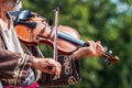 Open air concert. A professional musician performs a tune on a violin_ Royalty Free Stock Photo