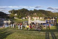 Open air event by the Elbe River bank at sunset.