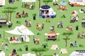 Open-air festival in park. People relaxing at street food fest with trucks, tents. Public picnic, camp in nature on