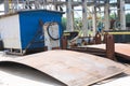 An open-air production site at an industrial plant, a workshop for welding large iron metal barrels and containers made of metal