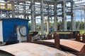 An open-air production site at an industrial plant, a workshop for welding large iron metal barrels and containers made of metal