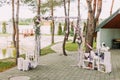 The open air wedding concept of the vintage wedding arch decorated with flowers and surrounded by wooden boxes and