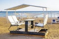 Open alcove, bar, cafe, terrace with table and chairs for visitors on sand beach, tropical sea resort.Summer vacation on warm Royalty Free Stock Photo