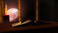 Open antique book and burning candle on red moon background Royalty Free Stock Photo