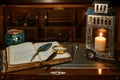 An open antique book in which a magnifying glass and a writing pen rest. are found on a wooden desk on leather. Two lighted