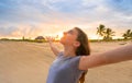 Open arms girl at sunset caribbean beach