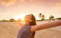 Open arms girl at sunset caribbean beach