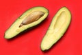 Open avocado on red background