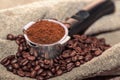 An open bag of coffee beans. Holder filter with ground coffee for coffee machines. Close up. Royalty Free Stock Photo