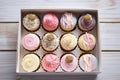 an open bakery box with a selection of cupcakes Royalty Free Stock Photo